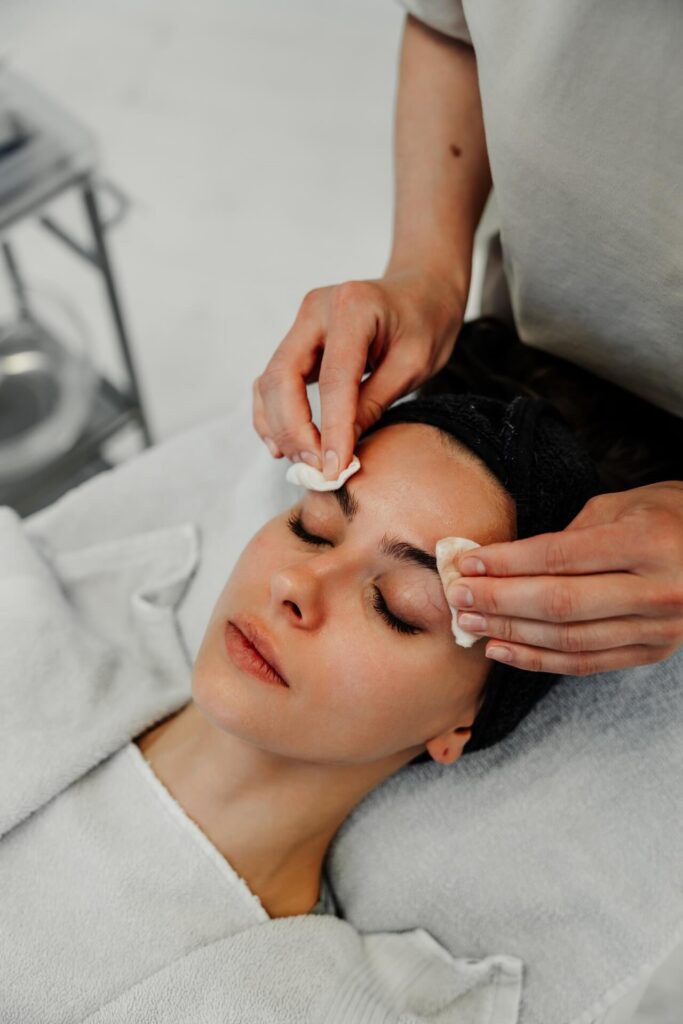 Gentle facial cleansing at Lalwa Aesthetics, therapist removing makeup for refreshed, healthy-looking skin.
