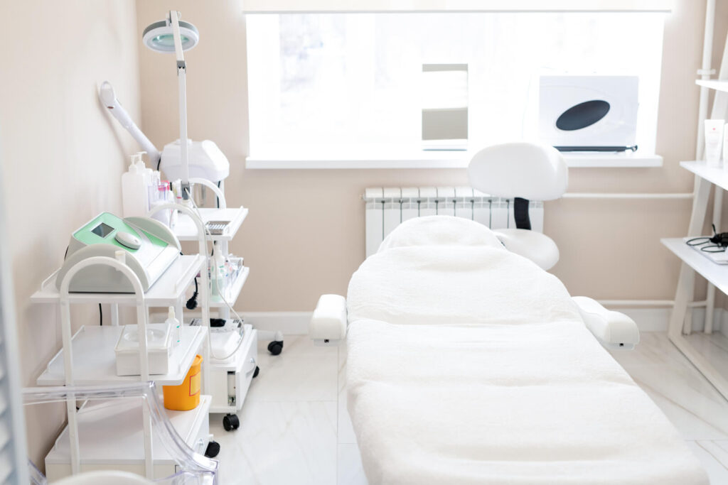 Clean aesthetic clinic room with treatment bed, skincare equipment and organized medical tools in a bright setting at Lalwa Aesthetics